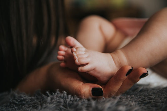 Image by Public Co from Pixabay--baby feet with mom's hands