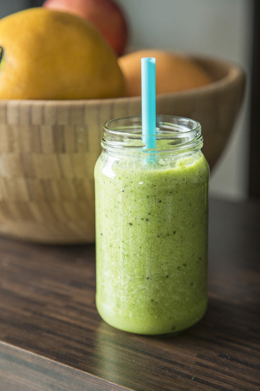 Image by Milada Vigerova from Pixabay--Green Smoothie with fruit in the background.